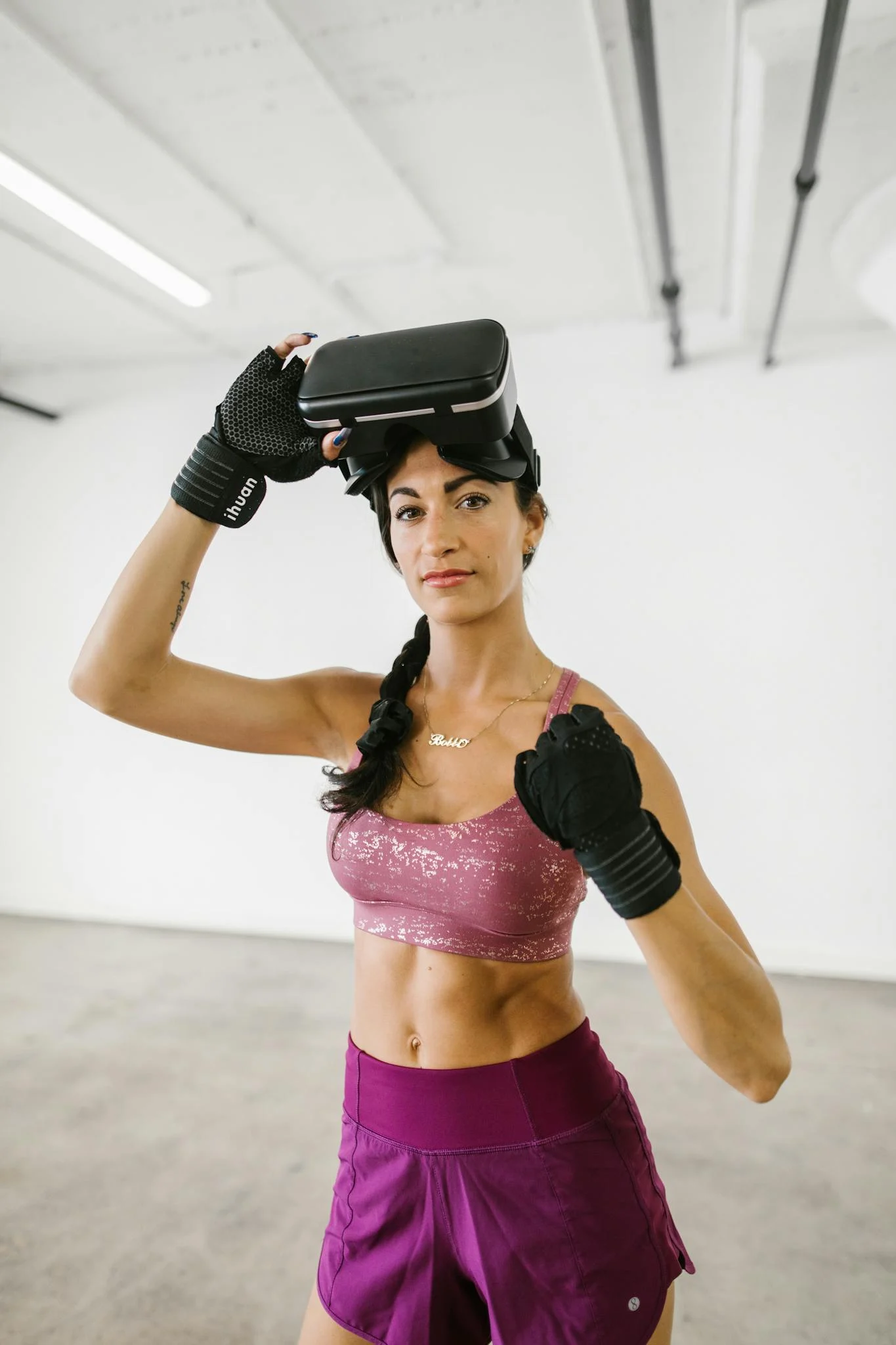 Athletic woman in a gym wearing a VR headset and workout gear. Perfect for modern lifestyle and fitness concepts.