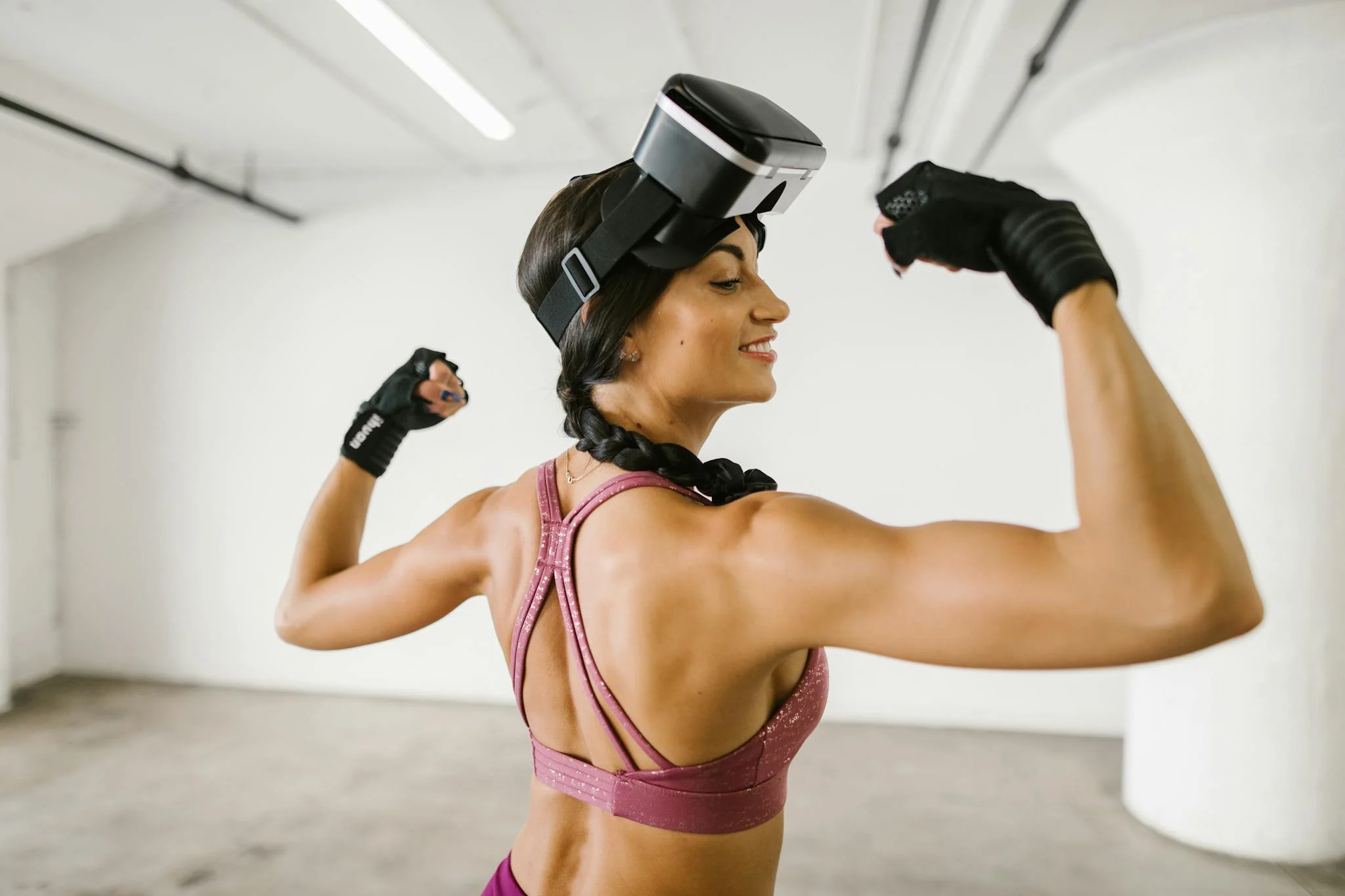 Fit woman using VR headset for immersive workout indoors. Embrace fitness tech.